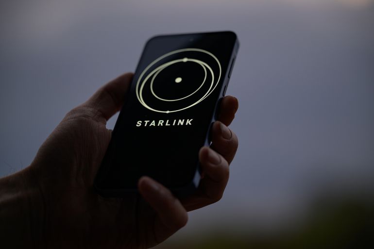 The Starlink logo is displayed on a mobile phone in this photo illustration in Brussels, Belgium, on March 23, 2025. (Photo by Jonathan Raa/NurPhoto via Getty Images)