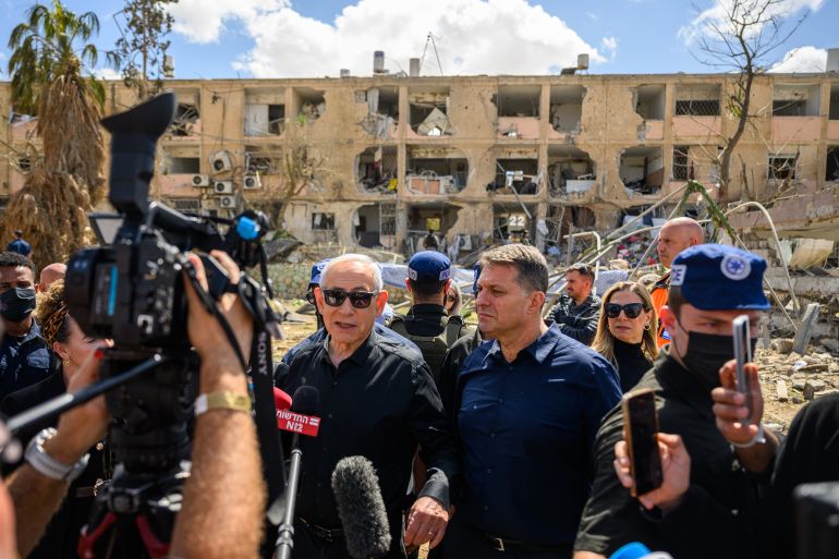DIMONA, - MARCH 22: : Israeli Prime Minister Benjamin (Bibi) Netanyahu, accompanied by Dimona Mayor, Benny Biton, speak to media while visiting the area destroyed by an Iranian ballistic missile last night, leaving over 50 wounded residents on March 22, 2026 in Dimona, Israel. Iran has continued firing waves of drones and missiles at Israel after the United States and Israel launched a joint attack on Iran early on February 28th. (Photo by Alexi Rosenfeld/Getty Images)