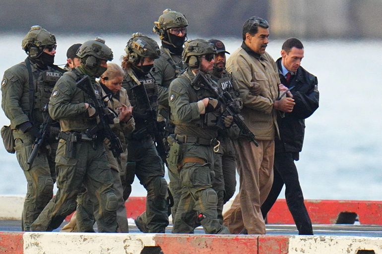 NEW YORK, NY - JANUARY 5: Nicolas Maduro and his wife, Cilia Flores, are seen in handcuffs after landing at a Manhattan helipad, escorted by heavily armed Federal agents as they make their way into an armored car en route to a Federal courthouse in Manhattan on January 5, 2026 in New York City. (Photo by XNY/Star Max/GC Images)