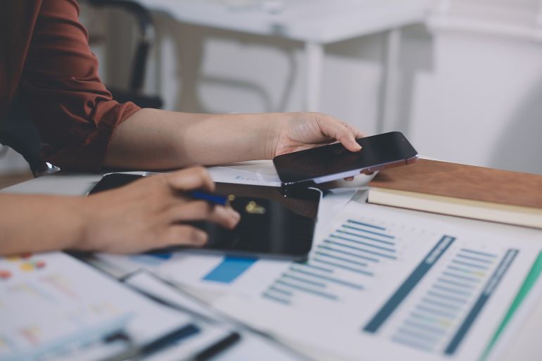 Closeup image of a businesswoman using mobile phone in office
