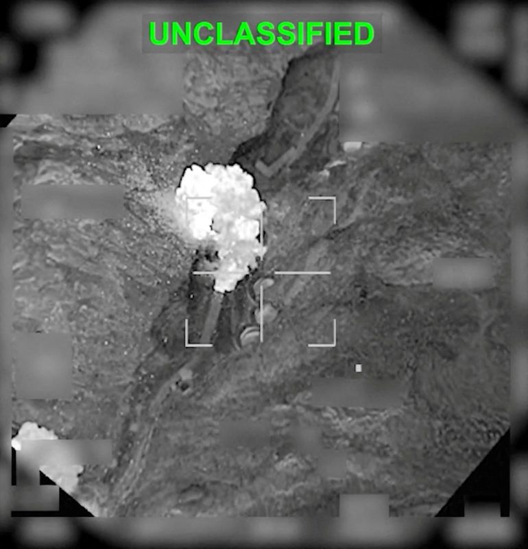reuters_69c51519-1774523673 An explosion following a strike on an Iranian facility in Haji Abad, Iran in this still image obtained from a video released by U.S. Central Command (CENTCOM) on March 20, 2026. CENTCOM/Handout via REUTERS THIS IMAGE HAS BEEN SUPPLIED BY A THIRD PARTY. MANDATORY CREDIT. TEXT OVERLAY AND BLURRING FROM SOURCE. VERIFICATION: The location was confirmed from the road layout and infrastructure which matched satellite imagery of the area. The shape of the valley matched the topography mapping of the area. The exact date could not be verified but no older version of the video was found posted online before March 20. The site was identified as an Iranian missile base by several military analysts.