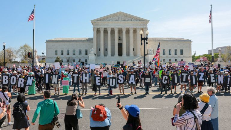 Demonstrators hold letters making up the slogan "Born in the USA = citizen!" outside the U.S. Supreme Court building as the court hears oral arguments on the legality of the Trump administration's effort to limit birthright citizenship for the children of immigrants, in Washington, D.C., U.S., April 1, 2026. REUTERS/Kylie Cooper TPX IMAGES OF THE DAY