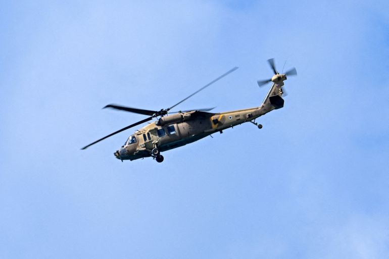 reuters_69d01928-1775245608 A Black Hawk helicopter flies over the coastline, amid the U.S.-Israeli conflict with Iran, as seen from Tel Aviv, Israel, March 8, 2026. REUTERS/Dylan Martinez