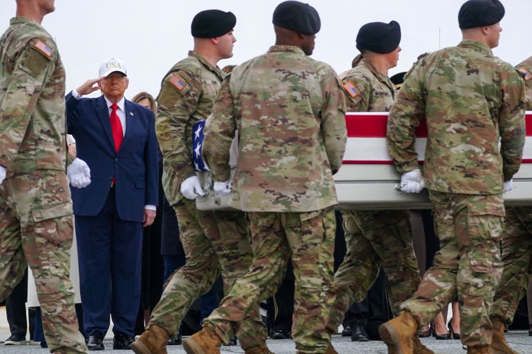 reuters_69d089a4-1775274404 U.S. President Donald Trump salutes as members of the military carry a transfer case during a dignified transfer of the remains of six U.S. Army service members of the 103rd Sustainment Command, who were killed in Kuwait, Major Jeffrey O'Brien, Capitain Cody Khork, Chief Warrant Officer 3 Robert Marzan, Sergeant 1st Class Nicole Amor, Sergeant 1st Class Noah Tietjens and Sergeant Declan Coady, amid the U.S.-Israeli conflict with Iran, at Dover Air Force Base in Dover, Delaware, U.S., March 7, 2026. REUTERS/Nathan Howard