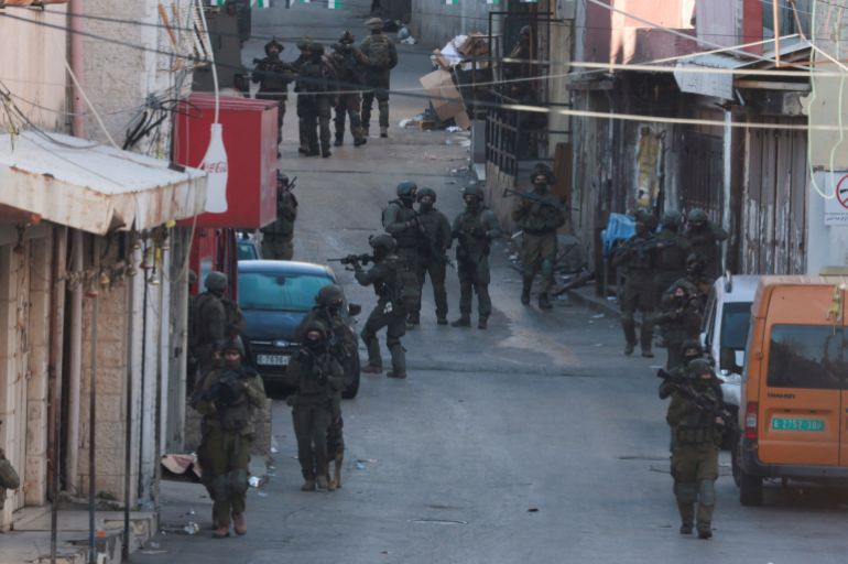 reuters_69d4d703-1775556355-1 Israeli soldiers take position during a raid, in Ramallah, in the Israeli-occupied West Bank March 17, 2026. REUTERS/Mohammed Torokman