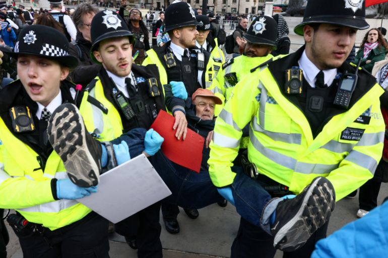 reuters_69db42cf-1775977167 Police officers detain a protester at 'Everyone Day', a mass vigil and sign-holding event in Trafalgar Square organised by Defend Our Juries to demand the lifting of the ban on Palestine Action, in London, Britain, April 11, 2026. REUTERS/Jack Taylor