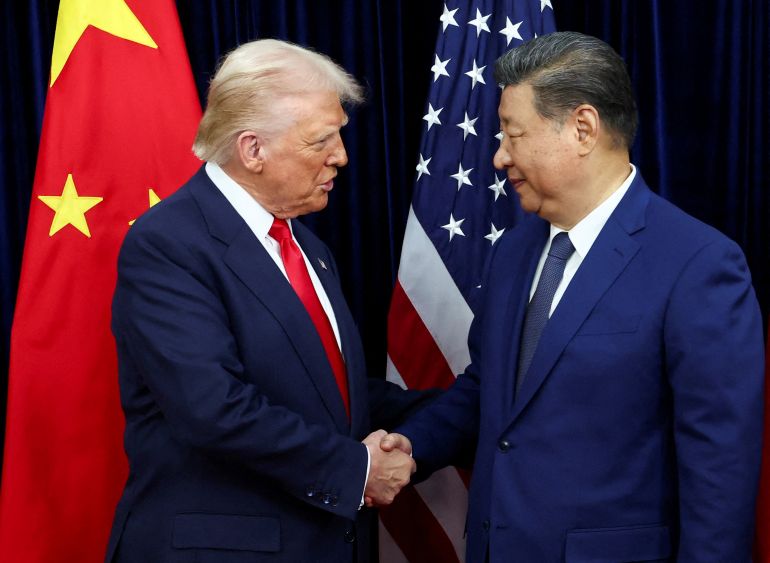 FILE PHOTO: U.S. President Donald Trump shakes hands with Chinese President Xi Jinping as they hold a bilateral meeting at Gimhae International Airport, on the sidelines of the Asia-Pacific Economic Cooperation (APEC) summit, in Busan, South Korea, October 30, 2025. REUTERS/Evelyn Hockstein/File Photo