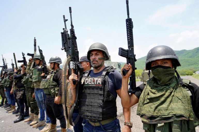 FILE PHOTO: Members of the Jalisco New Generation Cartel (CJNG), led by Nemesio Oseguera, known as “El Mencho,” pose for a photo at an undisclosed location in Michoacan state, Mexico, July 1, 2021. REUTERS/Stringer/File Photo