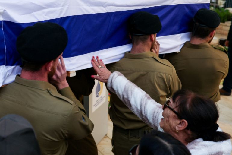reuters_69eca7c2-1777117122 A mourner touches the coffin, carried by soldiers, of Israeli Sergeant Liran Ben Zion, who, according to the Israeli army, was killed in combat in southern Lebanon, after Israeli forces launched a new campaign against Iran-backed Hezbollah in southern Lebanon and amid the U.S.-Israeli conflict with Iran, during his funeral in Holon, Israel March 30, 2026. REUTERS/Ronen Zvulun TPX IMAGES OF THE DAY