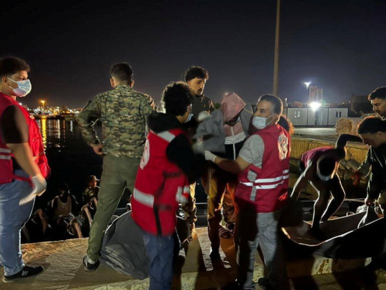 reuters_69f2ed2b-1777528107 Red Crescent volunteers assist a rescued person during recovery operations after a boat carrying migrants broke down and drifted for eight days in the Mediterranean Sea, in Tobruk, Libya, in this image released April 29, 2026. Libyan Red Crescent Society in Toburk/Handout via REUTERS THIS IMAGE HAS BEEN SUPPLIED BY A THIRD PARTY. MANDATORY CREDIT. NO RESALES. NO ARCHIVES. VERIFICATION Location verified by buildings, port layout and utility poles that matched file and satellite imagery Coordinates: 32.07672669591104, 23.980803260482272 Exact date not verified but no older versions of the pictures were found posted online before April 29, 2026.