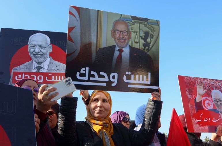 rtsggnje-1 Supporters of Rached Ghannouchi, head of the Islamist Ennahda party gather outside a court before his arrival for questioning