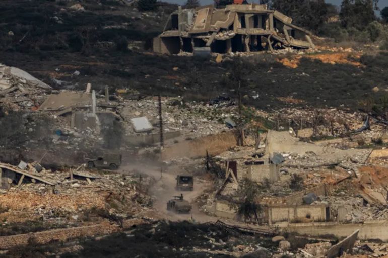 Israeli soldiers drive inside a village in southern Lebanon, as seen form northern Israel, Thursday, Jan. 23, 2025. (AP Photo/Ariel Schalit)