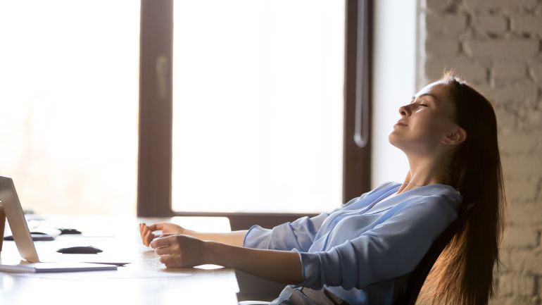 Calm happy businesswoman relaxing in comfortable office chair at work, satisfied manager resting with closed eyes after finished task during break, daydreaming, meditation, stress relief concept