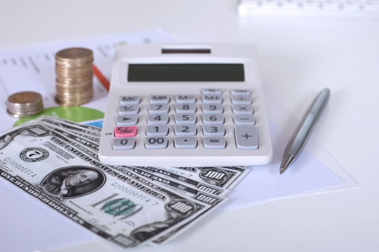 money and calculator over office desk