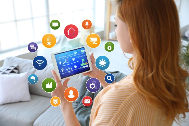 Woman using application of smart home automation