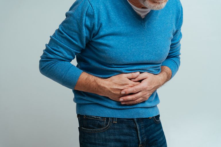 Handsome senior isolated on grey background. Old man feeling pain. Concept about the third age and seniority; Shutterstock ID 1988521742; purchase_order: aj; job: ; client: ; other:
