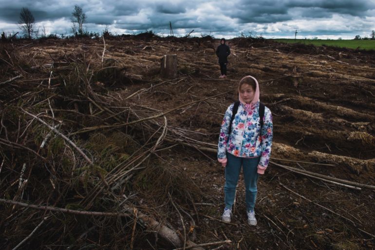 the surviving girl after enemy strikes looks into our eyes, standing on the ruins of her village. humanitarian catastrophe. nuclear war concept. the world is on the brink of disaster. no war.