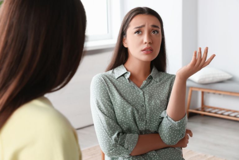 Professional psychologist working with young woman in office