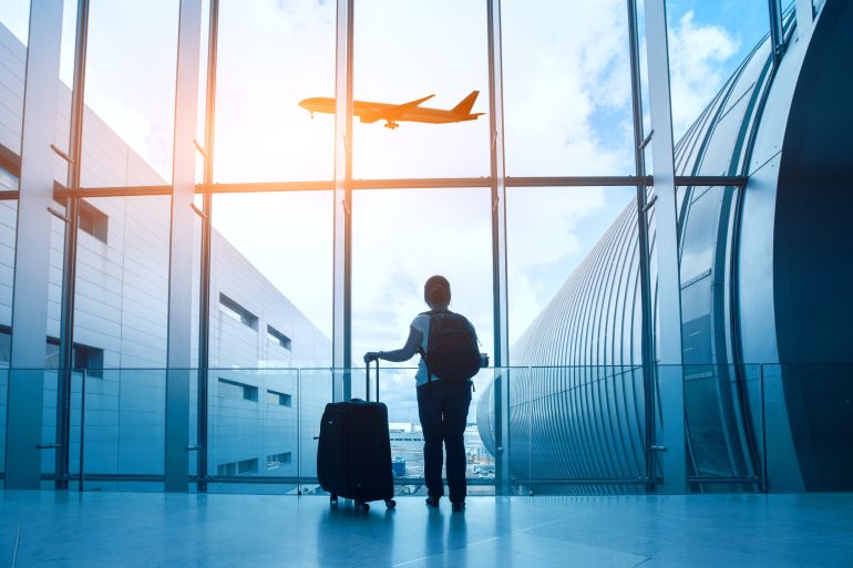 travel concept, woman in airport, passenger silhouette waiting with luggage in airport