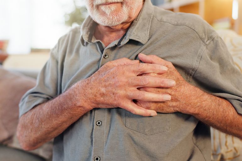 Old man, home and hands on chest for heart attack, pain and hypertension stress or lung fail. Elderly person, medical issue and cardiovascular disease or artery pressure, asthma and cardiac arrest; Shutterstock ID 2486702355; purchase_order: aj; job: ; client: ; other: