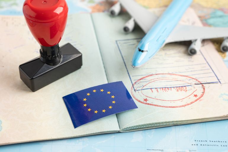 Eu flag with approved Stamp visa and passport document to immigration at airport in country.
