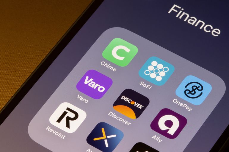 Portland, OR, USA - Apr 21, 2025: Assorted mobile banking apps, including Chime, SoFi, OnePay, Varo, Discover, Ally, Revolut, and Axos, are seen on the screen of an iPhone.; Shutterstock ID 2616237813; purchase_order: aj; job: ; client: ; other: