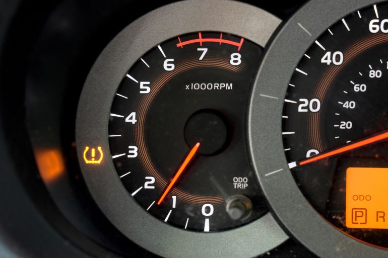 Orange check tire pressure symbol shows up on car dashboard