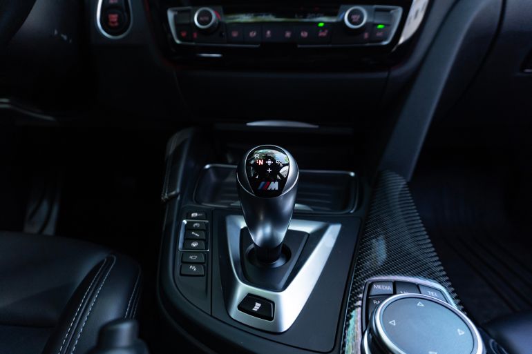 Minas Gerais, Brazil - 28 08 2025: BMW M3 F80 illuminated M-DCT gear shifter, Dual-clutch transmission sports sedan interior closeup
