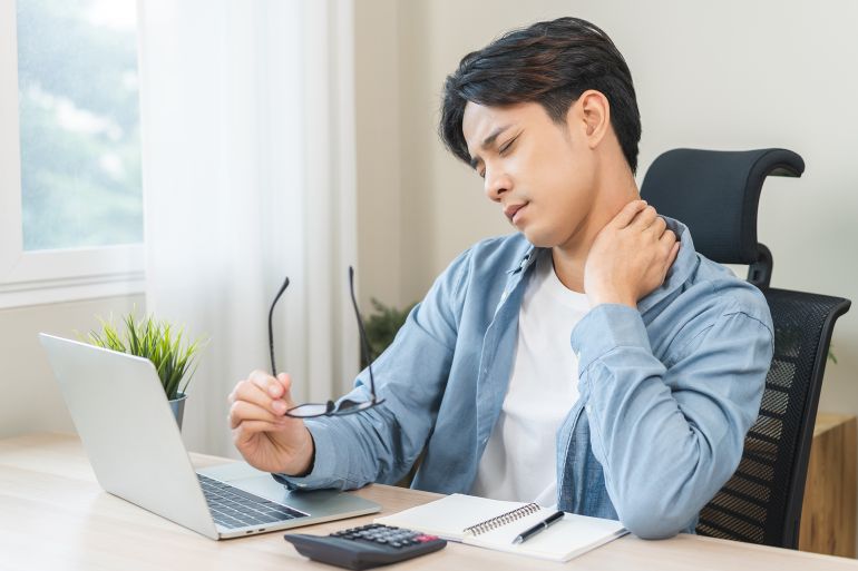 Body muscles stiff problem, ache asian young man pain neck and shoulder while sitting work on chair at home, male holding massaging rubbing, hurt or sore body. Healthcare people, office syndrome.; Shutterstock ID 2712527259; purchase_order: aj; job: ; client: ; other: