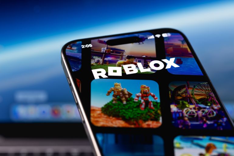 Roblox logo mobile app on a screen smartphone closeup. Roblox is an online game platform and game creation system built around user-generated content and games. Batumi, Georgia - November 12, 2025