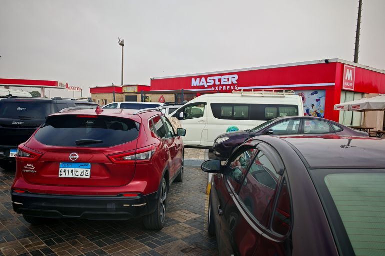 Red Nissan Qashqai and Black BAIC cars on front of Master Express Kiosk on Cairo Alex Desert Road, Egypt. 2nd Nov 2025.