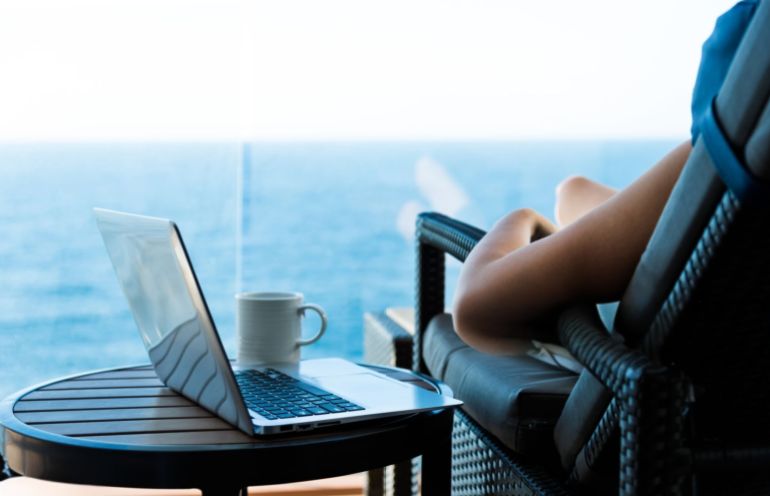 Woman working with a laptop on cruise ship.