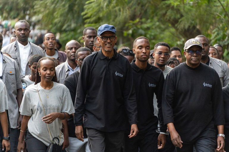 Rwanda's President Paul Kagame (C) walks in the street of Kigali during the "Walk to Remember" during the 31th comemoration of the 1994 Rwandan Genocide in Kigali on April 7, 2025.