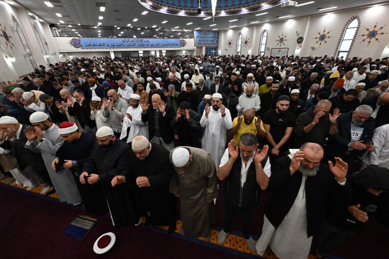 Muslim devotees offer Eid al-Adha prayers at the Lakemba Mosque in western Sydney, Australia, on May 27, 2026. Eid al-Adha marks the end of the Hajj pilgrimage to Mecca and commemorates the Prophet Abraham's willingness to sacrifice his son as an act of obedience to God, with the ritual centred on the slaughter of livestock.