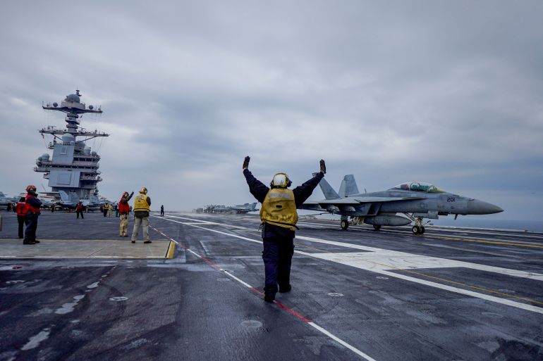 2023-05-military-us-1696915441 People stand onboard the American aircraft carrier USS Gerald R. Ford in the North Sea off Denmark, May 22, 2023. Hakon Mosvold Larsen/NTB/via REUTERS ATTENTION EDITORS - THIS IMAGE WAS PROVIDED BY A THIRD PARTY. NORWAY OUT. NO COMMERCIAL OR EDITORIAL SALES IN NORWAY.