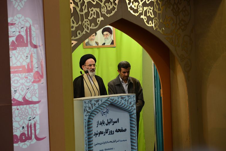 TEHRAN, IRAN - AUGUST 2: A clergyman speaks while bidding farewell to Iranian President Mahmoud Ahmadinejad (R) during Iran's 'International Quds Day' at the venue in Tehran university on August 2, 2013 in Tehran, Iran. Iran's outgoing President Mahmoud Ahmadinejad is leaving after eight years in office and end of his second term on August 4, when president-elect Hasan Rouhani is to be sworn in. (Photo by Kaveh Kazemi/Getty Images)