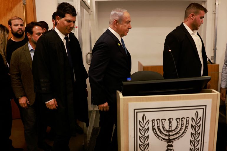 raeli Prime Minister Benjamin Netanyahu enters the district court in Tel Aviv at the start of his hearing on corruption charges on December 10, 2024.