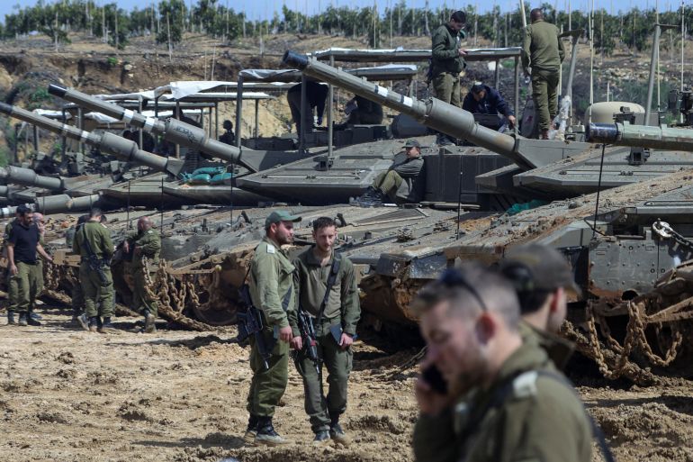 654-1779784255-2 Israeli soldiers stand next to tanks near the Israeli side of the border with Lebanon, amid escalation between Iran-backed Hezbollah and Israel and the U.S.-Israeli conflict with Iran, in northern Israel, March 23, 2026. REUTERS/Tyrone Siu