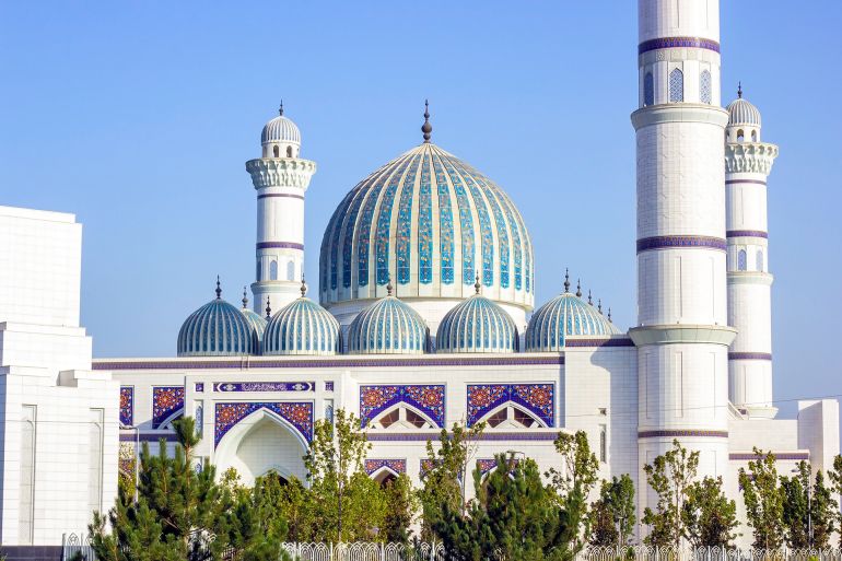DUSHANBE, TAJIKISTAN - AUGUST 11, 2022: White building of Central Cathedral Mosque of Dushanbe with mosaic ornament against the blue sky