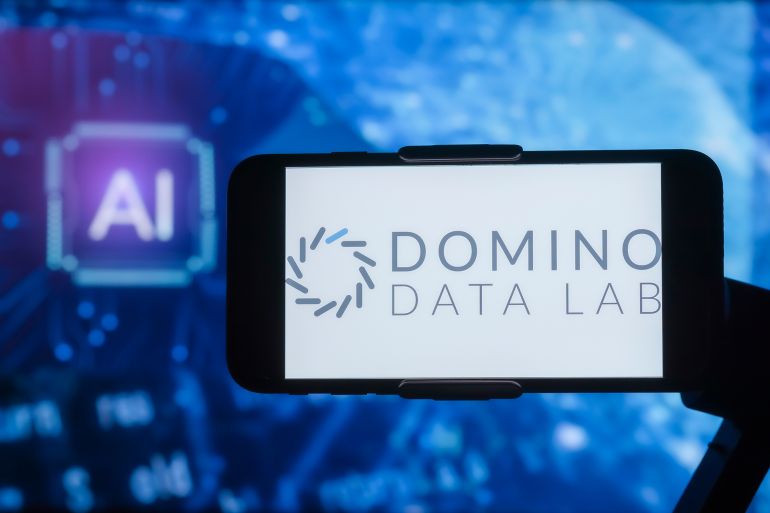INDIA - 2023/02/17: In this photo illustration, the logo of Domino Data Lab is seen displayed on a mobile phone screen with AI (artificial intelligence) written in the background. (Photo Illustration by Idrees Abbas/SOPA Images/LightRocket via Getty Images)
