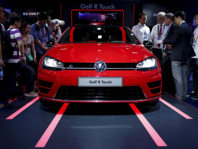 8a1dfad0-d2c4-4752-81ae-f9d8e2dc0e55 Attendees look at a Volkswagen Golf R Touch car during the 2015 International Consumer Electronics Show Asia in Shanghai, in this May 25, 2015 file picture. Automakers' latest projections for rapid growth of China's green car market have added to concerns of worsening smog as the uptake of electric vehicles powered by coal-fired grids races ahead of a switch to cleaner energy. REUTERS/Aly Song/Files
