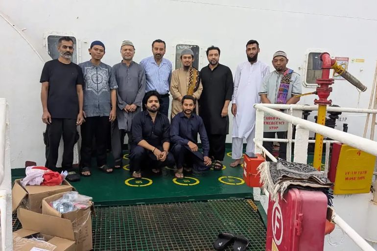 Several crew members of Honour 25 on board the ship before their vessel was hijacked. Ameen bin Shams is second from right in the front row. Mehmood Ansari is third from left standing [Courtesy Muzammil Ahmed Ansari]