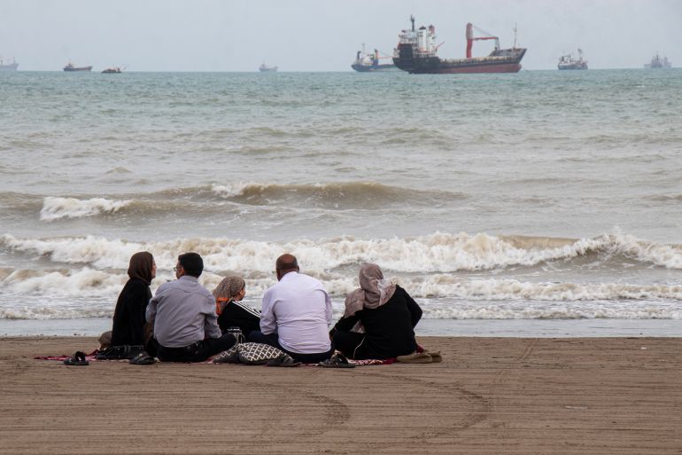 TOPSHOT - In this picture obtained from Iran's ISNA news agency on April 24, 2026, Iranians are seen at Suru Beach in Bandar Abbas along the Strait of Hormuz. (Photo by RAZIEH POUDAT / ISNA / AFP)