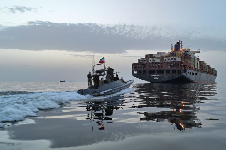 afp_69f486048bc5-1777632772 This photo obtained by AFP from the Iranian news agency Tasnim shows an Islamic Revolutionary Guard Corps (IRGC) boat allegedly taking part in an operation to seize ships attempting to cross the Strait of Hormuz, on April 21, 2026.