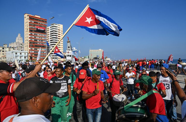 People march along Havana’s waterfront to mark International Workers’ Day at the Anti-Imperialist Platform in front of the US Embassy in Havana on May 1, 2026. (Photo by YAMIL LAGE / AFP)