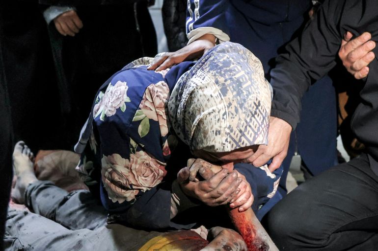 EDITORS NOTE: Graphic content / A woman mourns over the body of Palestinian child Mahmoud Sahwil, 14, who was killed during an Israeli strike on a police station in the Sheikh Radwan neighbourhood, as the body lies at the morgue at Shifa Hospital in Gaza City on May 5, 2026.
