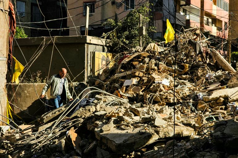 A man walks past rubble following an Israeli airstrike the previous day in the Haret Hreik neighbourhood of Beirut's southern suburbs on May 7, 2026.