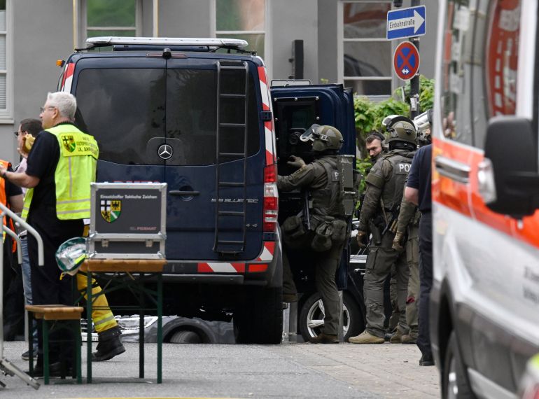 Police and rescue services are seen near a bank, where bank robbers have taken multiple hostages in Sinzig, western Germany on May 8, 2026.