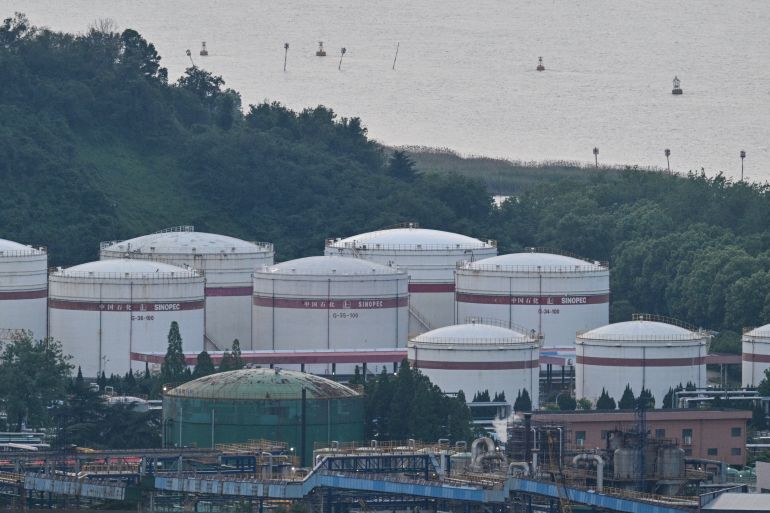 Sinopec storage tanks are seen at the crude oil refinery Sinopec Jinling Petrochemical Plant in Nanjing, in China's eastern Jiangsu province on May 8, 2026. (Photo by HECTOR RETAMAL / AFP)