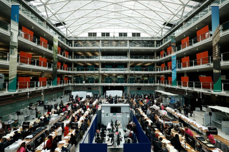 Staff count ballots the morning after local elections at a vote-counting centre inside the count centre for Hackney, north east London on May 8, 2026.
